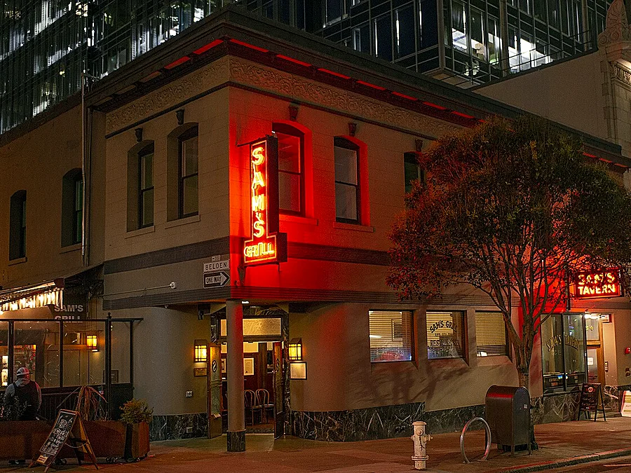 Sam's Grill neon sign at night